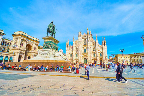 MILAN, ITALY - APRIL 11, 2022: Piazza del Duomo square with its main landmarks, such as Duomo, Galleria and statue to Vittorio Emanuele II, on April 11 in Milan, Italy
