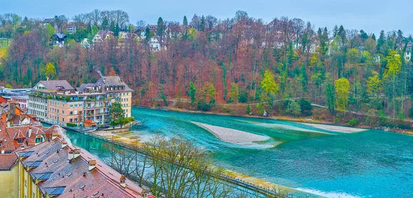 The lush park on the slope on the bank of Aare river opposite Old town of Bern, Switzerland