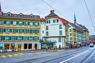 BERN, SWitzERLAND - 31 Mart 2022: Kornhausplatz meydanında yeşil pencereli tarihi konak evleri ile kent manzarası, 31 Mart 'ta İsviçre' nin Bern kentinde