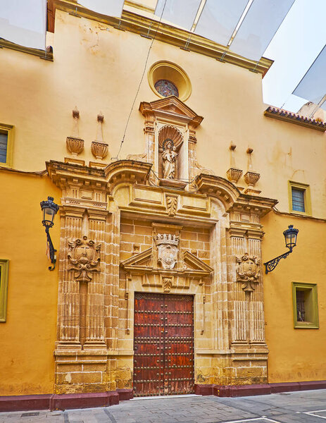The carved stone facade of historic Las Esclavas del Sagrado Corazon Church, located on Calle Luna, El Puerto, Spain