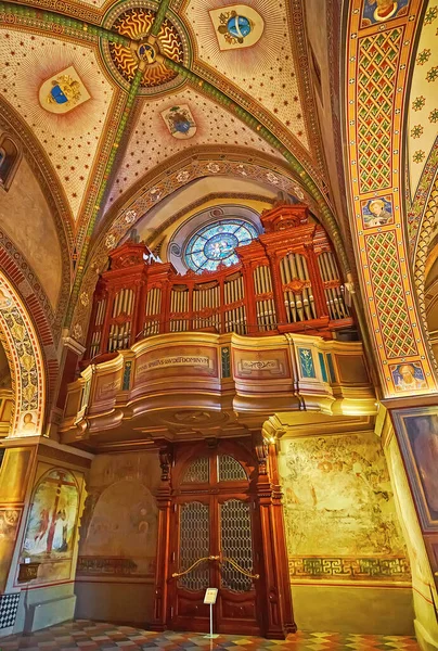 stock image LUGANO, SWITZERLAND - MARCH 14, 2022: The carved wooden pipe organ and fine frescoes in San Lorenzo Cathedral, Lugano, Switzerland