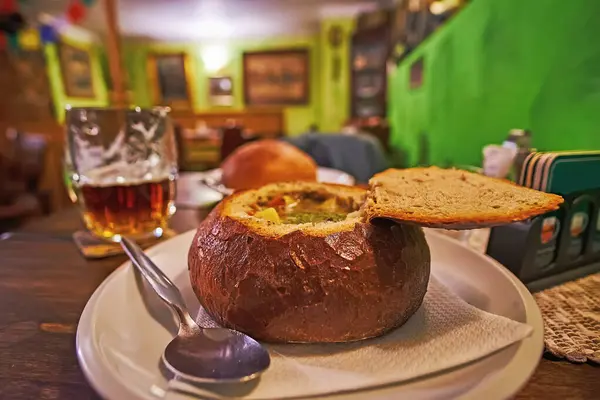 A veggie soup in bread bowl is a traditional Czech dish, can be found in restaurants and taverns of Prague, Czechia