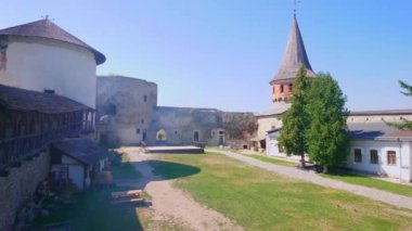 Tarihi Kamianet-Podilskyi Şatosu geçit töreni alanı, korunmuş taş duvarlar ve kuleler, ziyaretçilere açık, Ukrayna