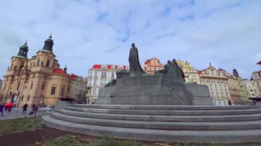 Tarihi Aziz Nicholas Kilisesi, anıtsal Jan Hus Anıtı, süslü kasaba evleri ve Çek Cumhuriyeti Prag, Prag 'da uzun taş saat kulesiyle eski belediye binası manzarası ile Eski Şehir Meydanı' nda sakin boş bir sabah.