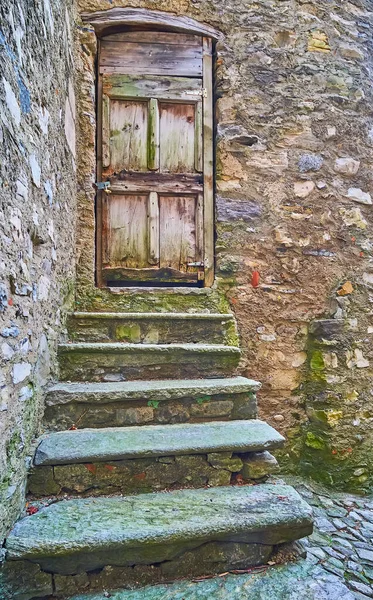 The medieval house with the old stone stairs and the shabby wooden door, Bre, Ticino, Switzerland