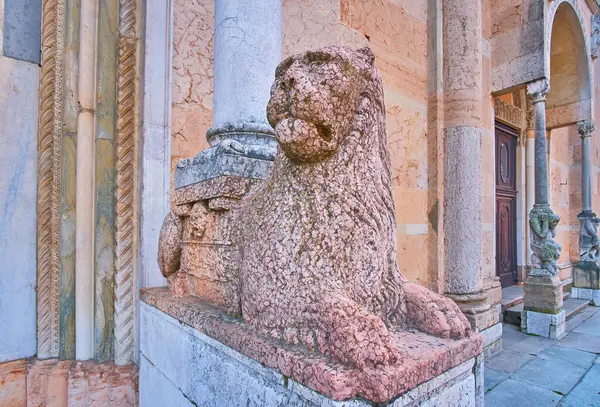 The ancient statue of lion is a column base at the gate of Duomo di Piacenza, Italy