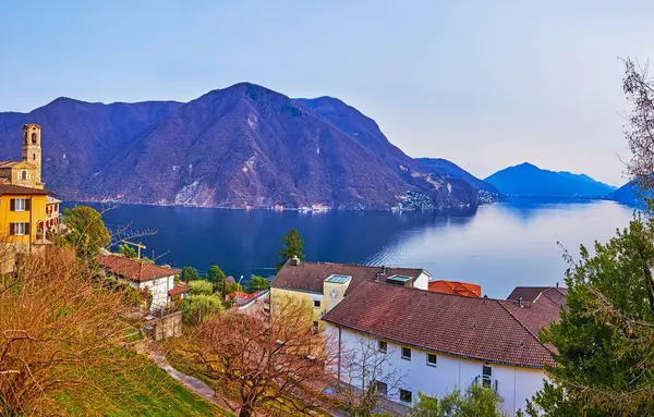 The roofs and gardens of Castagnola against blue Lake Lugano and Monte Sighignola, Ticino, Switzerland