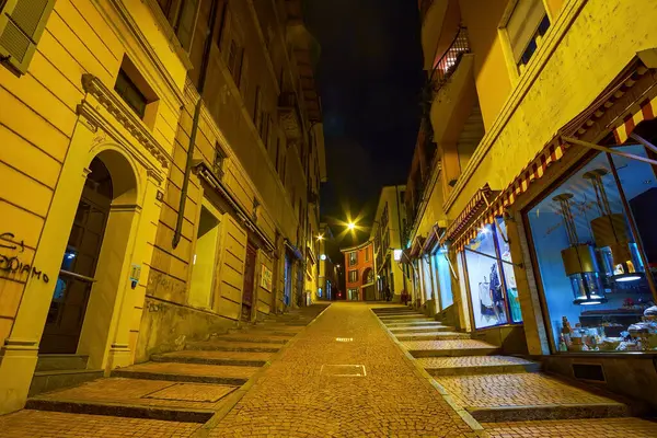 LUGANO, SWitzERLAND - 17 Mart 2022 Via Cattedrale caddesinde kapalı dükkanlar ve butiklerle geçen gece sahnesi, 17 Mart 'ta İsviçre' nin Lugano kentinde