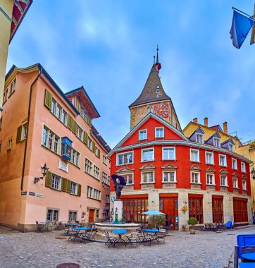 ZURİH, SWitzERLAND - 3 Nisan 2022: Neumarkt caddesindeki Grimmenturm kulesi ve Nike Fountain, 3 Nisan 'da İsviçre' nin Zürih kentinde