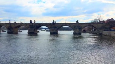 Ortaçağ Gotik Charles Köprüsü panoraması, Vltava Nehri 'nde yüzen bir tekne ve Çek Cumhuriyeti' nin Prag 'daki Stare Mesto semtinin karşı kıyısında yer alıyor.