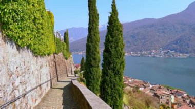 Observe the old tile roofs of Morcote, Lake Lugano and mountains from the hilltop, Switzerland