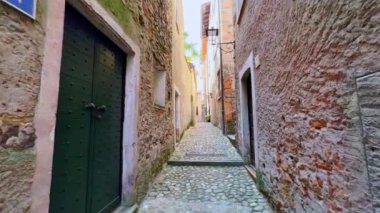 Explore narrow streets with preserved medieval houses in old town of Morcote, Switzerland