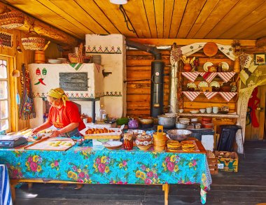 YABLUNYTSYA, UKRAINE - 24 Temmuz 2021 'de Yablunytsya' da, köy restoranında, kerevit fırını ve aşçıyla birlikte mutfağın içi, Dağ Vadisi Biberleri (Polonyna Pertsi), çörekleri yapıyor.