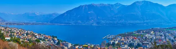 stock image Lake Maggiore panorama with Locarno city and Alpine mountain range in background, Ticino, Switzerland
