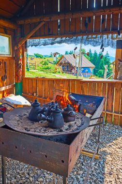 Coffee brewing on the open fire in the barn of village cafe, Mountain Valley Peppers, Carpathians, Ukraine clipart
