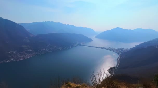 Hazy Lake Lugano Reflecting Sun Clouds Melide Causeway Slope Monte — Stock video
