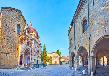 Panorama of the stone Piazza Duomo of Citta Alta with Baptistery, Capella Colleoni, Basilica of Santa Maria Maggiore and Palazzo della Ragione, Bergamo, Italy clipart