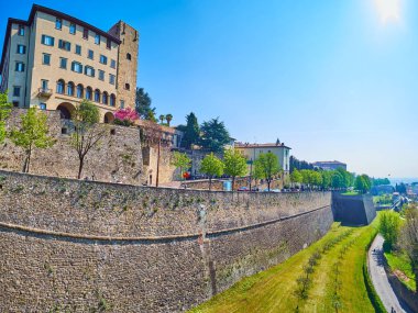 Panorama of green park, stretching along Vialle delle Mura street and medieval ramparts of Citta Alta (upper town) of Bergamo, Italy clipart