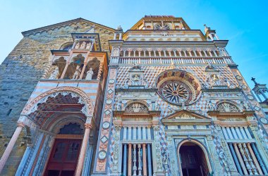 The richly decorated sculptured facades of Basilica of Santa Maria Maggiore and Capella Colleoni, Bergamo, Italy clipart