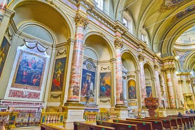 BERGAMO, ITALY - APRIL 7, 2022: The side chapels of Basilica of Sant'Alessandro in Colonna, decorated with historic paintings and carved stone altars, Citta Bassa, Bergamo, Italy clipart