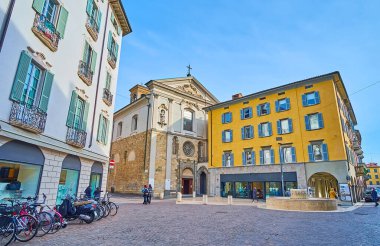 The facade of the oldest in Citta Bassa (lower town) San Leonardo Church with a fountain in the foreground,  Largo Nicolo Rezzara, Bergamo, Italy clipart