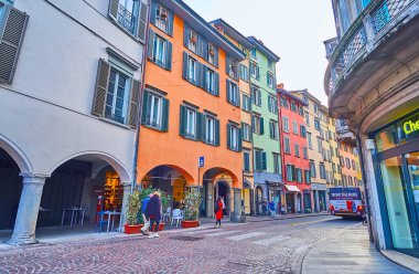 BERGAMO, ITALY - APRIL 7, 2022: The line of colored houses on Via XX Settembre in Citta Bassa (lower town), Bergamo, Italy clipart
