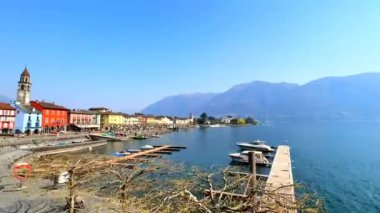 Maggiore Gölü 'ndeki balıkçı tekneleri, küçük kafeler, yüksek palmiye ağaçları, Piazza Giuseppe Motta, Ascona, İsviçre' deki tarihi renkli evler manzaralı göl kenarında yürüyüşün tadını çıkarın.