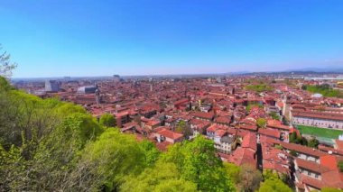 The panoramic skyline of old Brescia with red tile roofs, domes, towers from Cidneo Hill, Lombardy, Italy