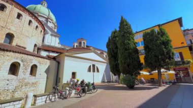 Panorama of the medieval stone Old Cathedral, massive dome of New Cathedral, Via Trieste street and colored housing of Piazza Paolo VI, Brescia, Lombardy, Italy