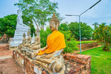 Sitting Buddha statues of Wat Yai Chai Mongkhonarchaeological complex, Ayutthaya, Thailand clipart