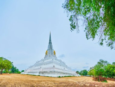Scenic white Chedi Wat Phukhao Thong temple in Ayutthaya city, Thailand clipart