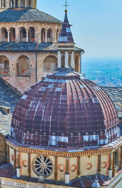 Historic dome of Cappella Colleoni with carved decors against the roof, covered with stone plates, Bergamo, Italy clipart