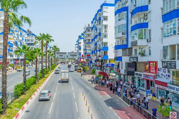 stock image ANTALYA, TURKEY - MAY 13,2017: The modern residential quarters and tall green palms on Yener Ulusoy Boulevard in Antalya, Turkey