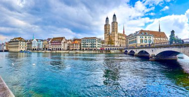 ZURICH, SWITZERLAND - APRIL 3, 2022: Zurich's iconic skyline boasts the Grossmunster and Fraumunster churches, set against the backdrop of the picturesque Limmat River panorama, on April 3 in Zurich, Switzerland clipart