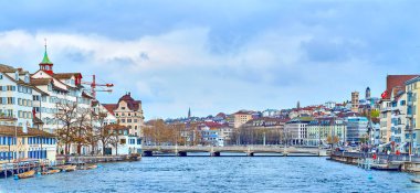 ZURICH, SWITZERLAND - APRIL 3, 2022: A panoramic view of downtown Zurich, encompassing both sides of the Limmat River, on April 3 in Zurich, Switzerland clipart