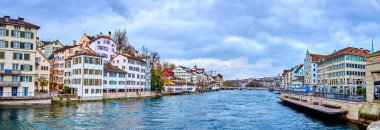 ZURICH, SWITZERLAND - APRIL 3, 2022: Zurich's iconic skyline boasts the Grossmunster and Fraumunster churches, set against the backdrop of the picturesque Limmat River panorama, on April 3 in Zurich, Switzerland clipart