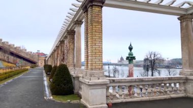 Tuna Nehri 'nin sisli manzarası, Szechenyi Zinciri Köprüsü ve Budapeşte, Macaristan' daki Budapeşte, Budapeşte, Macaristan 'daki ağaç bitkileri, yayalar ve tuğla sütunlarla dolu Budist Çarşısı' ndan Parlamento.