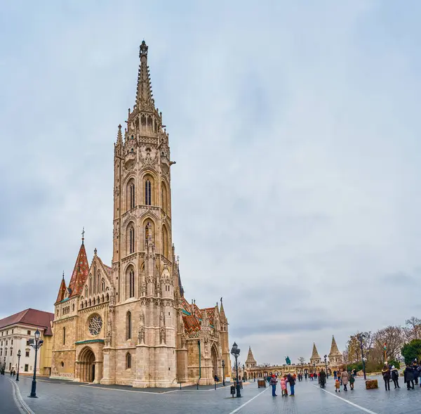 stock image BUDAPEST, HUNGARY - FEBRUARY 21, 2022: Matthias Church with its tall bell tower, the symbol of Fisherman's Bastion, on February 21 in Budapest, Hungary