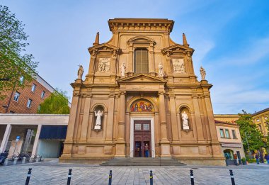 The Neoclassical facade of San Bartolomeo and San Stefano Church, decorated with wall columns, stone sculptures and fresco over the door, Bergamo, Italy clipart