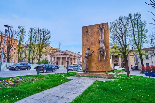 stock image BERGAMO, ITALY - APRIL 7, 2022: The green park with bronze Monument to Partisan by Giacomo Manzu on Piazza Giacomo Matteotti, Bergamo, Italy