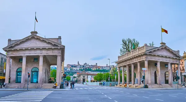 stock image Porta Nuova gate (Barriera delle Grazie) with two neoclassical buildings on both sides of Viale Papa Giovanni XXIII, Bergamo, Italy