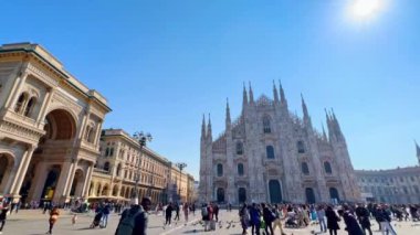 MILAN, ITALY - 5 Nisan 2022: Kalabalık ve yoğun Katedral Meydanı (Piazza del Duomo) ile süslü Gotik Duomo cephesi (Katedral) ve Galleria Vittorio Emanuele II alışveriş galerisi, 5 Nisan 'da Milano' da