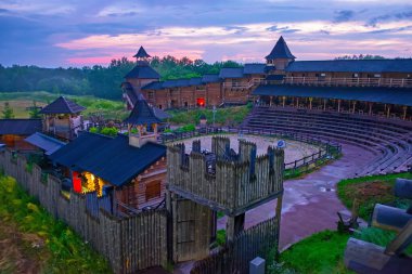 The bright evening sky over the fortifications and tournament field of Kyiv Rus Ethno Park, Ukraine clipart