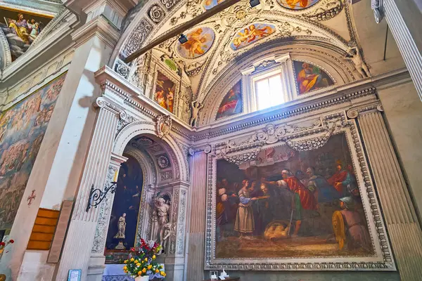 stock image CARONA, SWITZERLAND - MARCH 22, 2022: The beautiful frescoes and rich stucco decorations in Parish Church of St George and St Andrew in Carona, Ticino, Switzerland