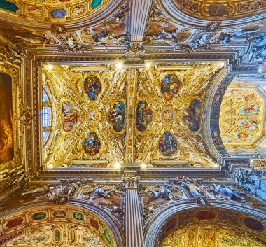 BERGAMO, ITALY - APRIL 7, 2022: The ornate vault and arcades of Santa Maria Maggiore Basilica with stucco decors, sculptures, paintings and fine gilt patterns, Bergamo, Italy clipart