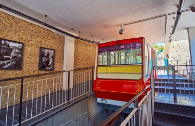 BERGAMO, ITALY - APRIL 7, 2022: The vintage car of Bergamo-San Vigilio funicular has arrived to its lower station in Citta Alta of Bergamo, Lombardy, Italy clipart