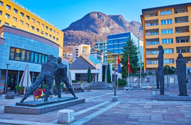 LUGANO, SWITZERLAND - MARCH 22, 2022: The modern sculptures by Ivo Soldini on the Paradiso Town Hall Square (Piazza Municipio), Lugano, Switzerland clipart