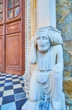 The medieval stone male Telamon, holding the column of Porta dei Leoni Bianchi (White Lions Gate), Basilica of Santa Maria Maggiore, Bergamo, Italy clipart