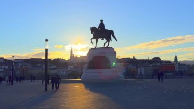 Gyula Andrassy monument against the sunset sky and Buda skyline, Budapest, Hungary