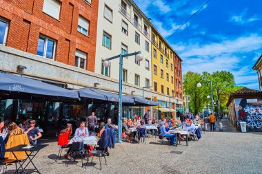 MILAN, İTALYA - 08 Nisan 2022: Corso di Porta Ticinese, 8 Nisan 'da İtalya' nın Milano kentinde yerel restoranların açık hava koltuklarıyla sıralanmıştı.